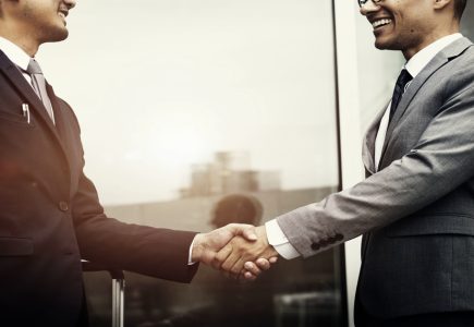 Corporate businessmen shaking hands